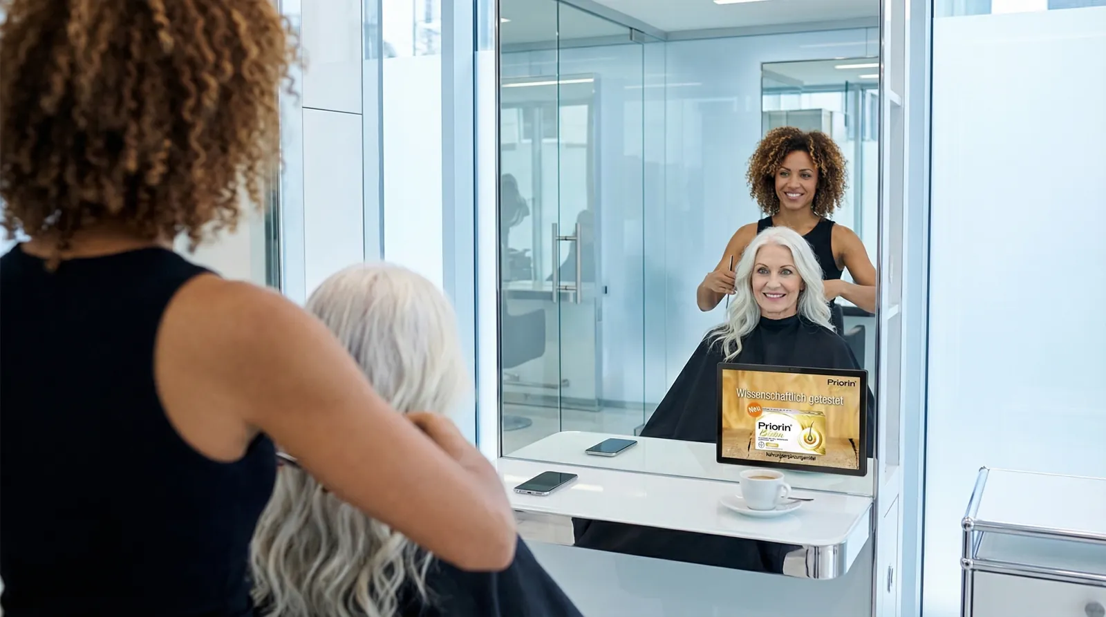 Frau, 60 im Coiffeursalon, auf dem Screen der Spot von Bayer